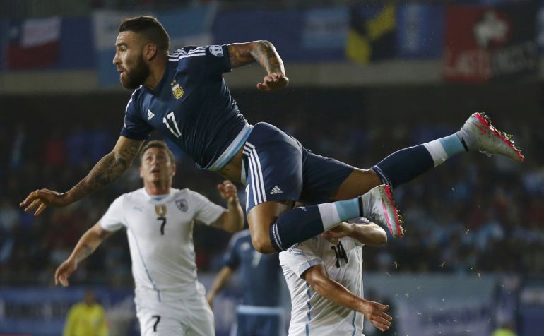 Argentina's Nicolas Otamendi jumps over Uruguay's Marcelo Lodeiro as Uruguay's Cristian Rodriguez (7) looks on during their first round Copa America 2015 soccer match at Estadio La Portada in La Serena, Chile, June 16, 2015.
REUTERS/Marcos Brindicci Argentina's Nicolas Otamendi jumps over Uruguay's Marcelo Lodeiro as Uruguay's Cristian Rodriguez (7) looks on during their first round Copa America 2015 soccer match at Estadio La Portada in La Serena, Chile, June 16, 2015.
REUTERS/Marcos Brindicci