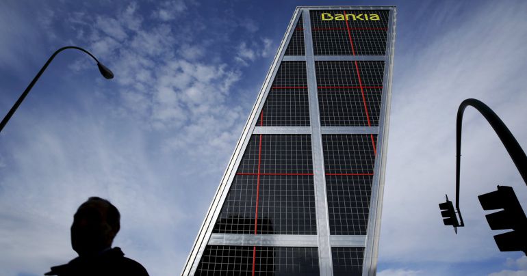 A man walks near the headquarters of Spanish nationalised lender Bankia in Madrid A man walks near the headquarters of Spanish nationalised lender Bankia in Madrid