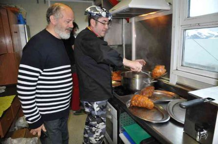 Valentín Carrera junto al cocinero que prepara el primer botillo antártico Valentín Carrera junto al cocinero que prepara el primer botillo antártico