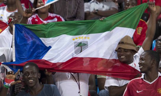 FILE- In this file photo dated Saturday, Nov. 16, 2013, supporters hold national flags of Ecuatorial Guinea before a friendly soccer match between Spain and the host nation of Ecuatorial Guinea, at Malabo Stadium in Malabo, Equatorial Guinea. Equatorial Guinea was chosen Friday Nov. 14, 2014, to host the 2015 African Cup of Nations soccer tournament, a decision that immediately stirred controversy because the country's national team was invited to participate despite being disqualified from the qualifying competition for cheating. (AP Photo/Diario AS, Juan Flor, FILE) FILE- In this file photo dated Saturday, Nov. 16, 2013, supporters hold national flags of Ecuatorial Guinea before a friendly soccer match between Spain and the host nation of Ecuatorial Guinea, at Malabo Stadium in Malabo, Equatorial Guinea. Equatorial Guinea was chosen Friday Nov. 14, 2014, to host the 2015 African Cup of Nations soccer tournament, a decision that immediately stirred controversy because the country's national team was invited to participate despite being disqualified from the qualifying competition for cheating. (AP Photo/Diario AS, Juan Flor, FILE)
