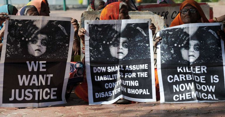 Bhopal Gas disaster survivors hold posters during a protest rally in Bhopal on December 2, 2014. The Bhopal industrial disaster, the world's worst industrial disaster in 1984, when gas leaked from a pesticides plant owned by the US multinational Union Carbide, killed about 4,000 people on the night of December 3, 1984 with the death toll over the next few years rising to 15,000, according to government estimates. Thirty years later, many of those who were exposed to the gas have given birth to physically and mentally disabled children. For decades, survivors have been fighting to have the site cleaned up, but they say the efforts were slowed when Michigan-based Dow Chemical took over Union Carbide in 2001. AFP PHOTO/ INDRANIL MUKHERJEE Bhopal Gas disaster survivors hold posters during a protest rally in Bhopal on December 2, 2014. The Bhopal industrial disaster, the world's worst industrial disaster in 1984, when gas leaked from a pesticides plant owned by the US multinational Union Carbide, killed about 4,000 people on the night of December 3, 1984 with the death toll over the next few years rising to 15,000, according to government estimates. Thirty years later, many of those who were exposed to the gas have given birth to physically and mentally disabled children. For decades, survivors have been fighting to have the site cleaned up, but they say the efforts were slowed when Michigan-based Dow Chemical took over Union Carbide in 2001. AFP PHOTO/ INDRANIL MUKHERJEE