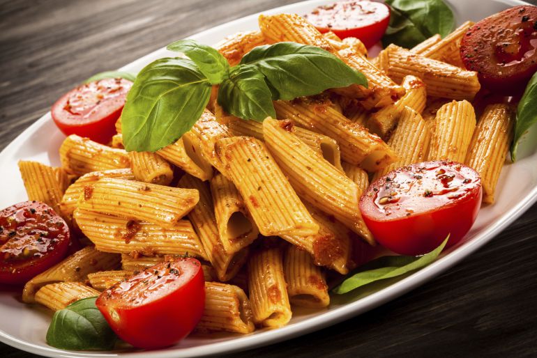 Un plato de pasta con tomate y chorizo. Un plato de pasta con tomate y chorizo.