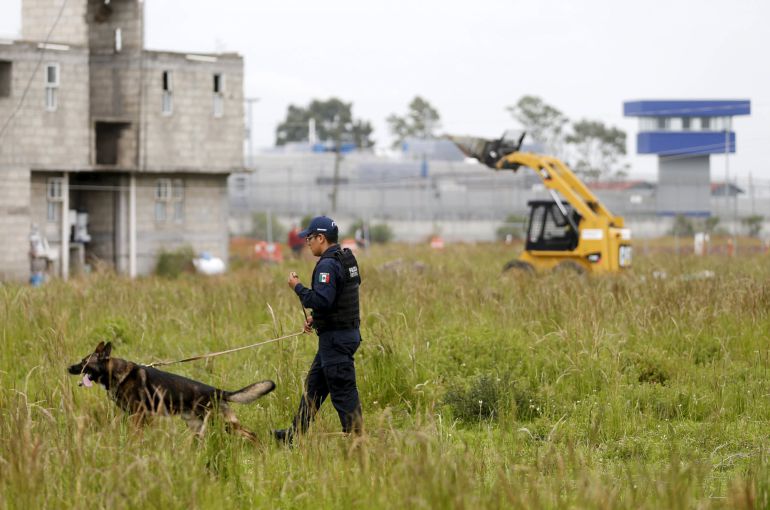 A police patrols with dogs near Altiplano Federal Penitentiary, where drug lord Joaquin "El Chapo" Guzman escaped from, in Almoloya de Juarez, on the outskirts of Mexico City, July 14 , 2015. Mexican authorities must have colluded with Joaquin "El Chapo" Guzman to enable the country's top drug lord to escape from a maximum security prison at the weekend, Interior Minister Miguel Angel Osorio Chong said on Monday. Guzman sparked a massive manhunt after escaping from Altiplano prison on Saturday night in a mile-long underground tunnel that led from his cell into a deserted building, dealing a bitter blow for President Enrique Pena Nieto. REUTERS/Edgard Garrido A police patrols with dogs near Altiplano Federal Penitentiary, where drug lord Joaquin "El Chapo" Guzman escaped from, in Almoloya de Juarez, on the outskirts of Mexico City, July 14 , 2015. Mexican authorities must have colluded with Joaquin "El Chapo" Guzman to enable the country's top drug lord to escape from a maximum security prison at the weekend, Interior Minister Miguel Angel Osorio Chong said on Monday. Guzman sparked a massive manhunt after escaping from Altiplano prison on Saturday night in a mile-long underground tunnel that led from his cell into a deserted building, dealing a bitter blow for President Enrique Pena Nieto. REUTERS/Edgard Garrido