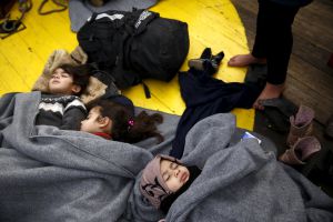 Children sleep on the deck of the rescue ship "Aegis 1", after a group of about 100 Syrian refugees that landed with rafts on the inhabited islet of Panayia, was retrieved by a Frontex patrol boat and transferred on the "Aegis 1", near the Greek island of Oinousses, January 28, 2016. REUTERS/Giorgos Moutafis GREECE OUT. NO COMMERCIAL OR EDITORIAL SALES IN GREECE Children sleep on the deck of the rescue ship "Aegis 1", after a group of about 100 Syrian refugees that landed with rafts on the inhabited islet of Panayia, was retrieved by a Frontex patrol boat and transferred on the "Aegis 1", near the Greek island of Oinousses, January 28, 2016. REUTERS/Giorgos Moutafis GREECE OUT. NO COMMERCIAL OR EDITORIAL SALES IN GREECE
