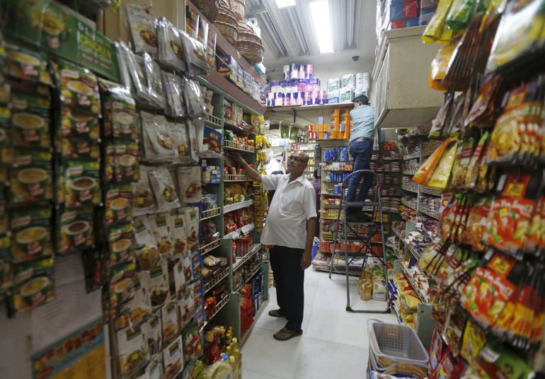 Employees work inside a grocery store at a residential area in Mumbai Employees work inside a grocery store at a residential area in Mumbai