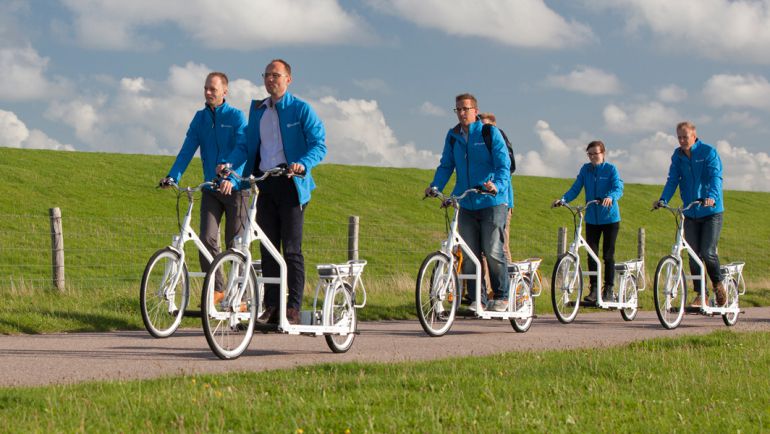 Este grupo uniformado de azul pasea por la campiña holandesa en su bicicleta que es a la vez una cinta de andar. Este grupo uniformado de azul pasea por la campiña holandesa en su bicicleta que es a la vez una cinta de andar.