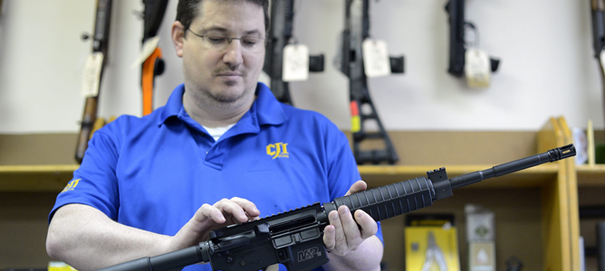 El propietario de una armería sostiene un rifle semiautomático de asalto MP15, el mismo que utilizó el autor de la masacre de Newtown, en su negocio en Tucker (Georgia, EEUU). El propietario de una armería sostiene un rifle semiautomático de asalto MP15, el mismo que utilizó el autor de la masacre de Newtown, en su negocio en Tucker (Georgia, EEUU).