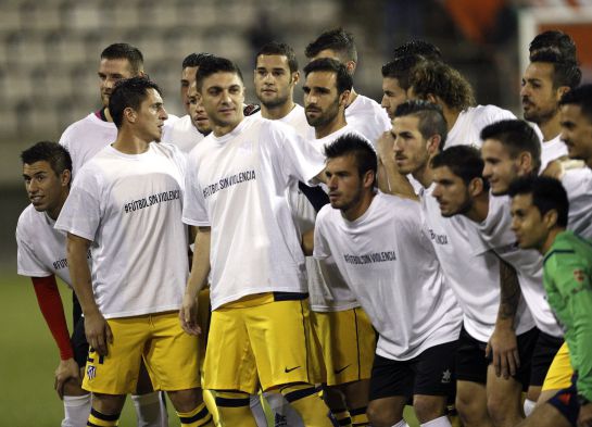 Los jugadores de L'Hospitalet y del Atlético de Madrid lucen camisetas antiviolencia antes de comenzar el partido de ida de dieciseisavos de final de la Copa del Rey. Los jugadores de L'Hospitalet y del Atlético de Madrid lucen camisetas antiviolencia antes de comenzar el partido de ida de dieciseisavos de final de la Copa del Rey.