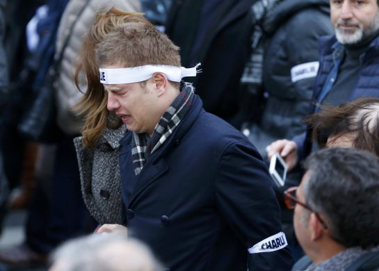A man reacts as he walks with family members and relatives of the seventeen victims during a solidarity march (Marche Republicaine) in the streets of Paris January 11, 2015. Hundreds of thousands of French citizens will be joined by dozens of foreign leaders, among them Arab and Muslim representatives, in a march on Sunday in an unprecedented tribute to this week's victims, including journalists and policemen, following the shootings by gunmen at the offices of the satirical weekly newspaper Charlie Hebdo, the killing of a police woman in Montrouge, and the hostage taking at a kosher supermarket at the Porte de Vincennes. REUTERS/Yves Herman (FRANCE - Tags: CRIME LAW POLITICS CIVIL UNREST SOCIETY) A man reacts as he walks with family members and relatives of the seventeen victims during a solidarity march (Marche Republicaine) in the streets of Paris January 11, 2015. Hundreds of thousands of French citizens will be joined by dozens of foreign leaders, among them Arab and Muslim representatives, in a march on Sunday in an unprecedented tribute to this week's victims, including journalists and policemen, following the shootings by gunmen at the offices of the satirical weekly newspaper Charlie Hebdo, the killing of a police woman in Montrouge, and the hostage taking at a kosher supermarket at the Porte de Vincennes. REUTERS/Yves Herman (FRANCE - Tags: CRIME LAW POLITICS CIVIL UNREST SOCIETY)