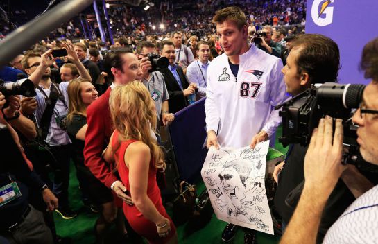 PHOENIX, AZ - JANUARY 27: Rob Gronkowski #87 of the New England Patriots walks with Johnny Weir and Tara Lipinski of NBC at Super Bowl XLIX Media Day Fueled by Gatorade inside U.S. Airways Center on January 27, 2015 in Phoenix, Arizona. Rob Carr/Getty Images/AFP == FOR NEWSPAPERS, INTERNET, TELCOS & TELEVISION USE ONLY == PHOENIX, AZ - JANUARY 27: Rob Gronkowski #87 of the New England Patriots walks with Johnny Weir and Tara Lipinski of NBC at Super Bowl XLIX Media Day Fueled by Gatorade inside U.S. Airways Center on January 27, 2015 in Phoenix, Arizona. Rob Carr/Getty Images/AFP == FOR NEWSPAPERS, INTERNET, TELCOS & TELEVISION USE ONLY ==