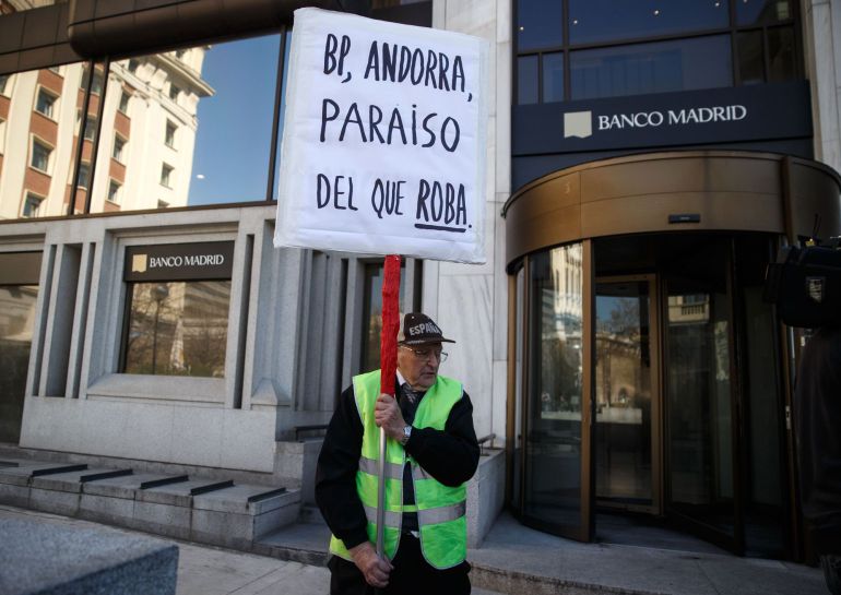 A man protests while holding a banner in Madrid March 11, 2015. The financial authority of tax haven Andorra has taken control of private bank Banca Privada D'Andorra (BPA) after the United States declared the lender as under suspicion for money laundering, the Andorran government said on Tuesday. The Bank of Spain said later on Tuesday it would take over Banco de Madrid, BPA's wholly-owned Spanish unit, in the interests of the lender's continuity following the events at BPA. The banner reads "BP, Andorra, paradise for thieves." REUTERS/Andrea Comas (SPAIN - Tags: BUSINESS POLITICS CIVIL UNREST) A man protests while holding a banner in Madrid March 11, 2015. The financial authority of tax haven Andorra has taken control of private bank Banca Privada D'Andorra (BPA) after the United States declared the lender as under suspicion for money laundering, the Andorran government said on Tuesday. The Bank of Spain said later on Tuesday it would take over Banco de Madrid, BPA's wholly-owned Spanish unit, in the interests of the lender's continuity following the events at BPA. The banner reads "BP, Andorra, paradise for thieves." REUTERS/Andrea Comas (SPAIN - Tags: BUSINESS POLITICS CIVIL UNREST)