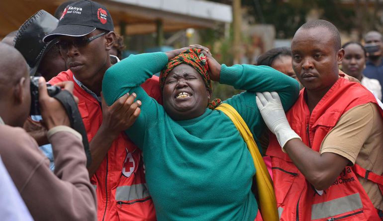 TOPSHOTS
Members of the Red Cross help a relative of one of the students massacred by Somalia's Shebab Islamists at a Kenyan university at the Chiromo funeral parlour in the Kenyan capital, Nairobi, on April 3, 2015. The bodies of dozens of students massacred by Somalia's Shebab Islamists at a Kenyan university in Garissa arrived in the capital today, as grieving relatives faced a desperate wait to receive the remains of their loved ones. AFP PHOTO / TONY KARUMBA TOPSHOTS
Members of the Red Cross help a relative of one of the students massacred by Somalia's Shebab Islamists at a Kenyan university at the Chiromo funeral parlour in the Kenyan capital, Nairobi, on April 3, 2015. The bodies of dozens of students massacred by Somalia's Shebab Islamists at a Kenyan university in Garissa arrived in the capital today, as grieving relatives faced a desperate wait to receive the remains of their loved ones. AFP PHOTO / TONY KARUMBA