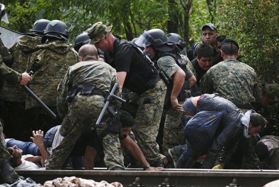 Migrants fall as they make their way through police to cross Greece's border into Macedonia near Gevgelija, Macedonia, August 22, 2015. Thousands of migrants stormed across Macedonia's border on Saturday, overwhelming security forces who threw stun grenades and lashed out with batons in an increasingly futile bid to stem their flow through the Balkans to western Europe. Some had spent days in the open with little or no access to food or water after Macedonia on Thursday declared a state of emergency and sealed its borders to migrants, many of them refugees from war in Syria and other conflicts in the Middle East. REUTERS/Ognen Teofilovski Migrants fall as they make their way through police to cross Greece's border into Macedonia near Gevgelija, Macedonia, August 22, 2015. Thousands of migrants stormed across Macedonia's border on Saturday, overwhelming security forces who threw stun grenades and lashed out with batons in an increasingly futile bid to stem their flow through the Balkans to western Europe. Some had spent days in the open with little or no access to food or water after Macedonia on Thursday declared a state of emergency and sealed its borders to migrants, many of them refugees from war in Syria and other conflicts in the Middle East. REUTERS/Ognen Teofilovski