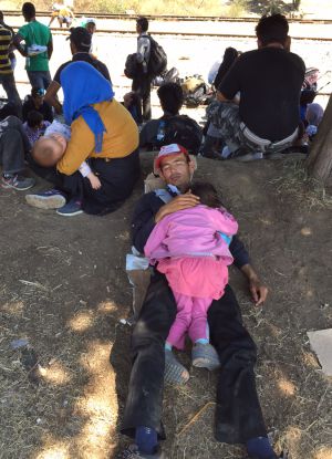 Un refugiado descansa junto a su hija en una de las escasas sombras Un refugiado descansa junto a su hija en una de las escasas sombras