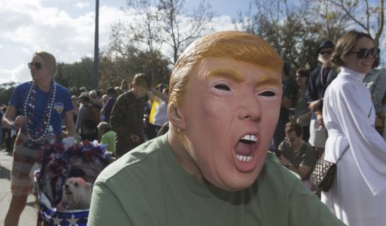 A man wearing a mask depicting U.S. Republican presidential candidate Donald Trump takes part in the Mystic Krewe of Barkus dog parade in the French Quarter of New Orleans, Louisiana January 31, 2016. REUTERS/Lee Celano A man wearing a mask depicting U.S. Republican presidential candidate Donald Trump takes part in the Mystic Krewe of Barkus dog parade in the French Quarter of New Orleans, Louisiana January 31, 2016. REUTERS/Lee Celano