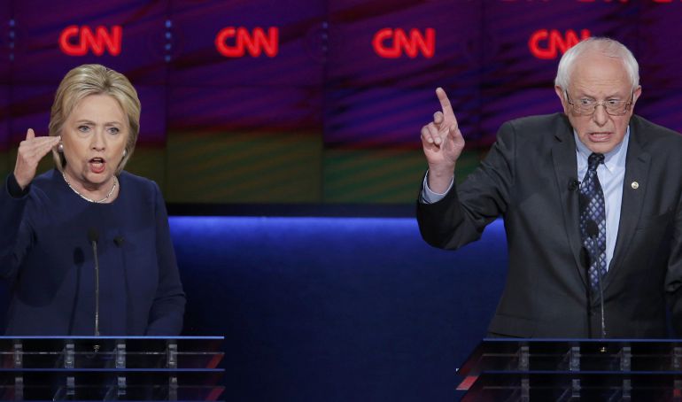 Democratic U.S. presidential candidate Hillary Clinton and rival Bernie Sanders speak simultaneously during the Democratic U.S. presidential candidates' debate in Flint, Michigan, March 6, 2016. REUTERS-Jim Young Democratic U.S. presidential candidate Hillary Clinton and rival Bernie Sanders speak simultaneously during the Democratic U.S. presidential candidates' debate in Flint, Michigan, March 6, 2016. REUTERS-Jim Young