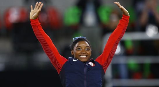 RIO DE JANEIRO, BRAZIL - AUGUST 11: Gold medalist Simone Biles of the United States celebrates on the podium at the medal ceremony for the Women's Individual All Around on Day 6 of the 2016 Rio Olympics at Rio Olympic Arena on August 11, 2016 in Rio de Janeiro, Brazil. (Photo by Amin Mohammad Jamali/Getty Images) RIO DE JANEIRO, BRAZIL - AUGUST 11: Gold medalist Simone Biles of the United States celebrates on the podium at the medal ceremony for the Women's Individual All Around on Day 6 of the 2016 Rio Olympics at Rio Olympic Arena on August 11, 2016 in Rio de Janeiro, Brazil. (Photo by Amin Mohammad Jamali/Getty Images)