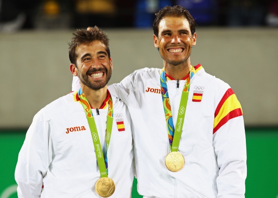 RIO DE JANEIRO, BRAZIL - AUGUST 12: (L-R) Gold medalists Rafael Nadal and Marc Lopez of Spain celebrate on the podium after the Men's Doubles competition on Day 7 of the Rio 2016 Olympic Games at the Olympic Tennis Centre on August 12, 2016 in Rio de Janeiro, Brazil. (Photo by Clive Brunskill/Getty Images) RIO DE JANEIRO, BRAZIL - AUGUST 12: (L-R) Gold medalists Rafael Nadal and Marc Lopez of Spain celebrate on the podium after the Men's Doubles competition on Day 7 of the Rio 2016 Olympic Games at the Olympic Tennis Centre on August 12, 2016 in Rio de Janeiro, Brazil. (Photo by Clive Brunskill/Getty Images)