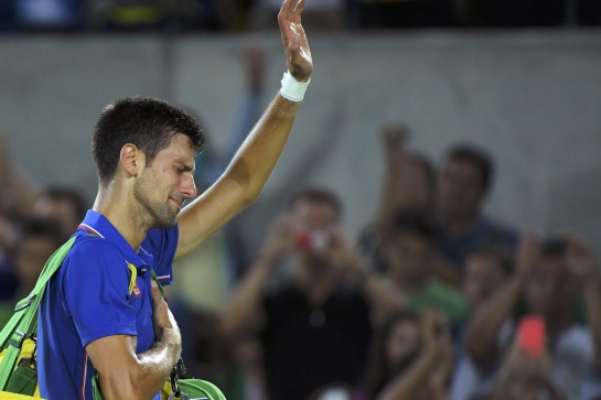 2016 Rio Olympics - Tennis - Preliminary - Men's Singles First Round - Olympic Tennis Centre - Rio de Janeiro, Brazil - 07/08/2016. Novak Djokovic (SRB) of Serbia reacts after losing his match against Juan Martin Del Potro (ARG) of Argentina. REUTERS/Toby Melville TPX IMAGES OF THE DAY. FOR EDITORIAL USE ONLY. NOT FOR SALE FOR MARKETING OR ADVERTISING CAMPAIGNS. 2016 Rio Olympics - Tennis - Preliminary - Men's Singles First Round - Olympic Tennis Centre - Rio de Janeiro, Brazil - 07/08/2016. Novak Djokovic (SRB) of Serbia reacts after losing his match against Juan Martin Del Potro (ARG) of Argentina. REUTERS/Toby Melville TPX IMAGES OF THE DAY. FOR EDITORIAL USE ONLY. NOT FOR SALE FOR MARKETING OR ADVERTISING CAMPAIGNS.