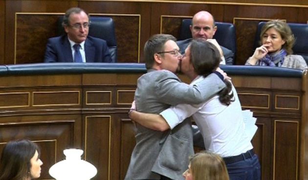 El líder de Podemos, Pablo Iglesias y el de En Comú Podem, Xavier Doménech, se besan en los labios al término de la intervención del diputado catalán. El líder de Podemos, Pablo Iglesias y el de En Comú Podem, Xavier Doménech, se besan en los labios al término de la intervención del diputado catalán.