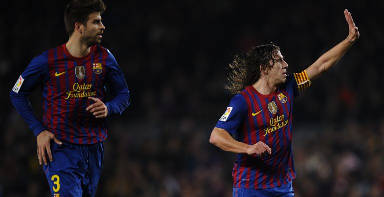 Piqué y Puyol, en un partido de febrero de 2012. Piqué y Puyol, en un partido de febrero de 2012.