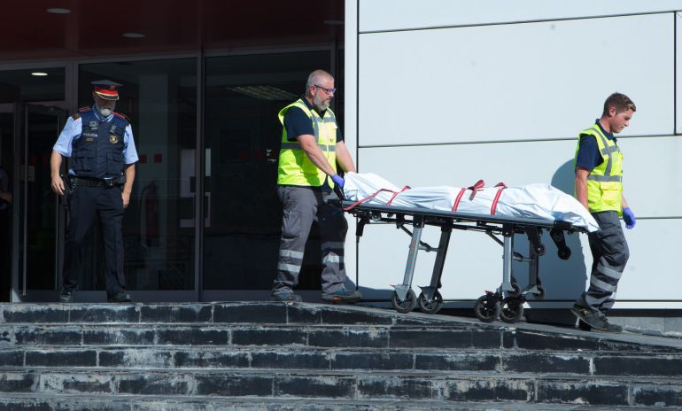 Miembros del servicio judicial retiran el cadáver del hombre que ha sido abatido esta mañana al intentar acceder a la comisaría de los Mossos de Cornellà con un cuchillo en la mano y al grito de "Alá es grande" Miembros del servicio judicial retiran el cadáver del hombre que ha sido abatido esta mañana al intentar acceder a la comisaría de los Mossos de Cornellà con un cuchillo en la mano y al grito de "Alá es grande"