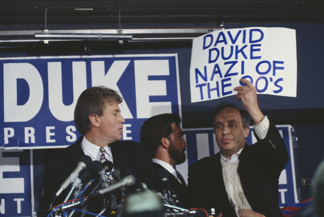 Protestas durante un acto de David Duke: "Nazi de los 90", se lee en una pancarta Protestas durante un acto de David Duke: "Nazi de los 90", se lee en una pancarta