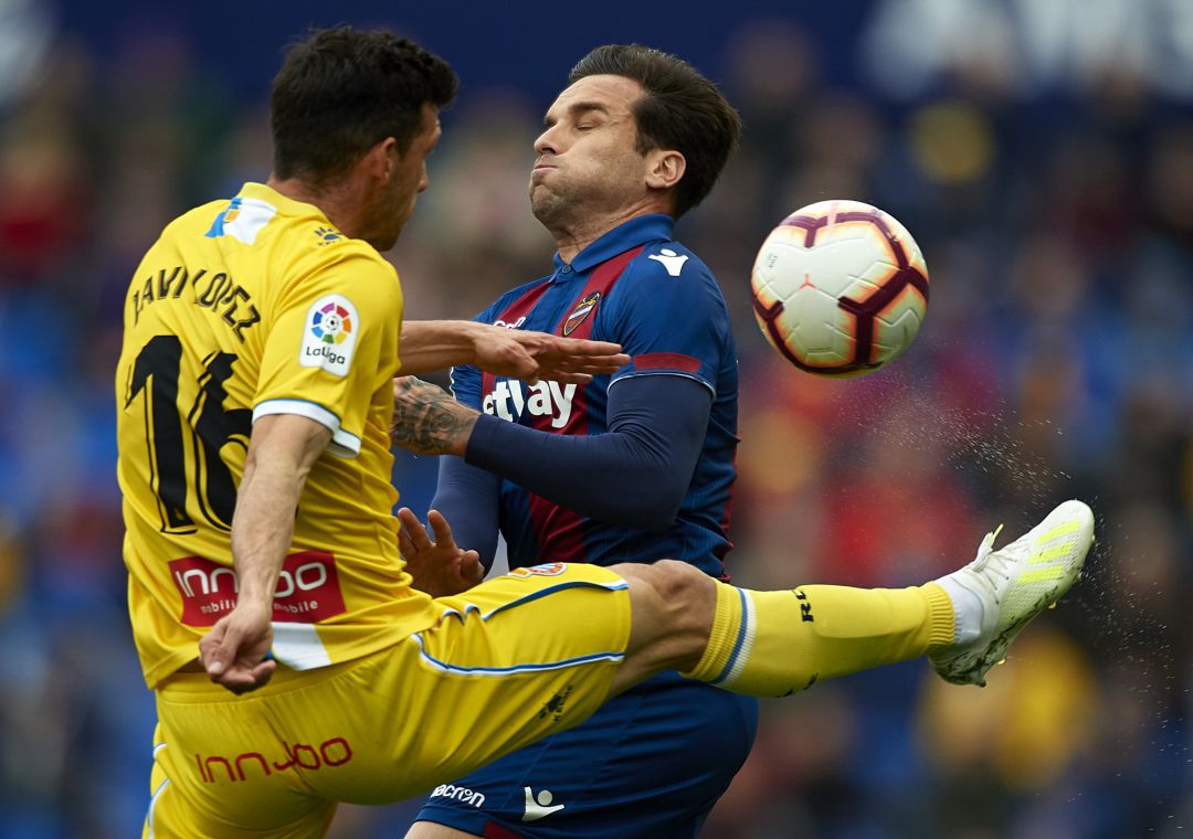 Toño Garcia of Levante competes for the ball with Javi Lopez of Espanyol during the La Liga match between Levante UD and RCD Espanyol Toño Garcia of Levante competes for the ball with Javi Lopez of Espanyol during the La Liga match between Levante UD and RCD Espanyol