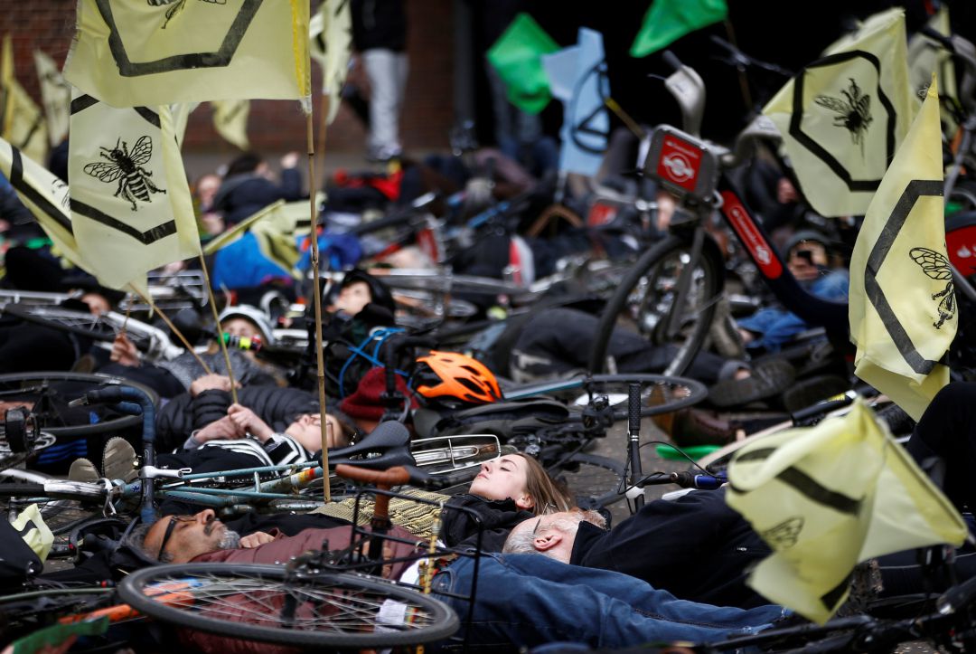 Cyclists lay down as they take part in the Extinction Rebellion protest at the Tate Modern in London, Cyclists lay down as they take part in the Extinction Rebellion protest at the Tate Modern in London,