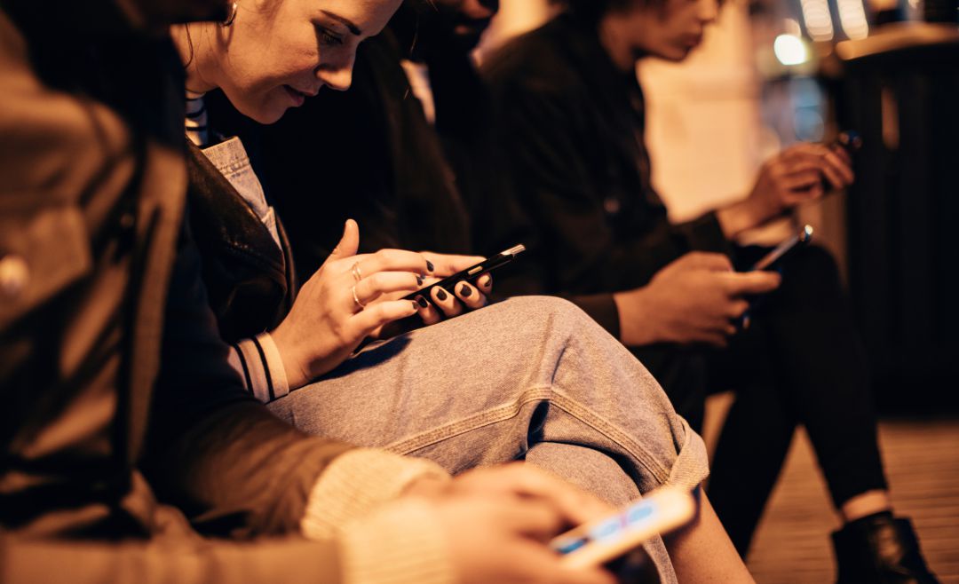 Varios usuarios consultando su teléfono móvil. Varios usuarios consultando su teléfono móvil.