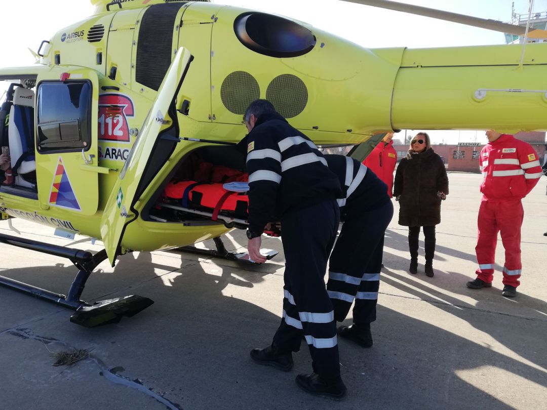 Pilotos del helicóptero del 112 entrando una de las camillas esta mañana en la base aérea de Zaragoza Pilotos del helicóptero del 112 entrando una de las camillas esta mañana en la base aérea de Zaragoza