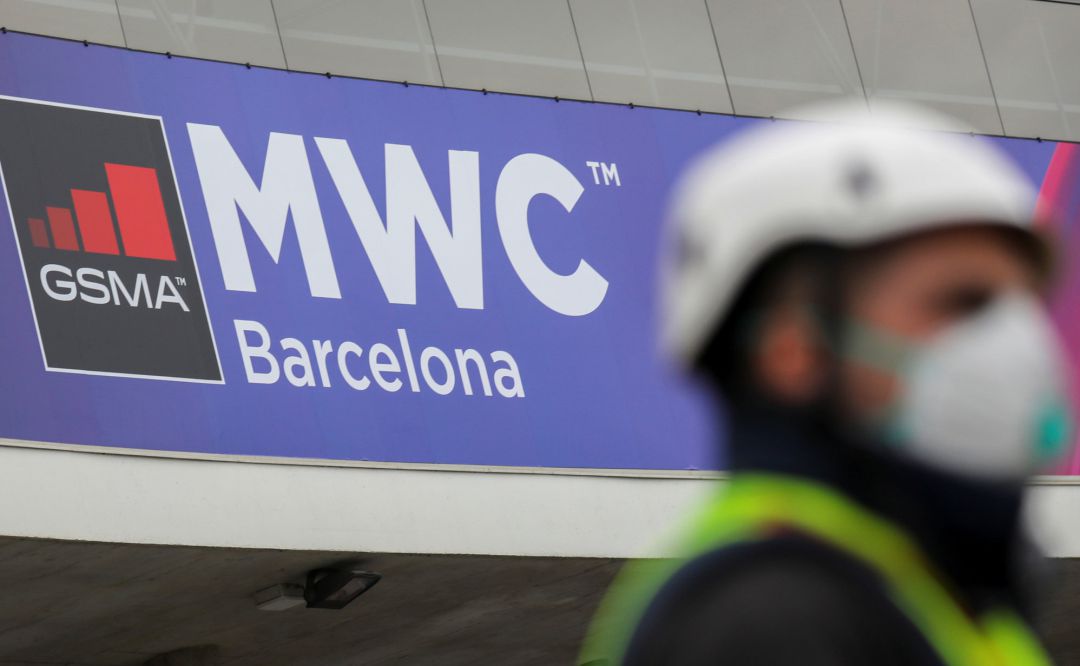 An employee is pictured next to the logo of MWC20 (Mobile World Congress) in Barcelona, Spain February 12, 2020 An employee is pictured next to the logo of MWC20 (Mobile World Congress) in Barcelona, Spain February 12, 2020