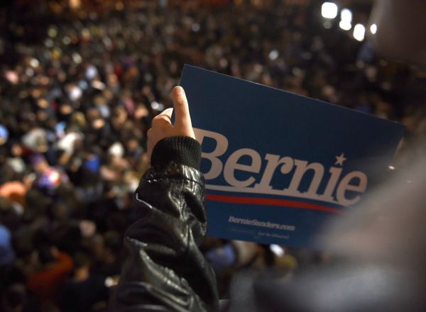 A supporter of U.S. Democratic presidential candidate Senator Bernie Sanders holds a Bernie campaign sign as she looks down on a large crowd waiting for him to arrive for a campaign rally after Sanders was projected to be the winner of the Nevada Caucus while in San Antonio, Texas, U.S. February 22, 2020. REUTERS/Callaghan O'Hare
