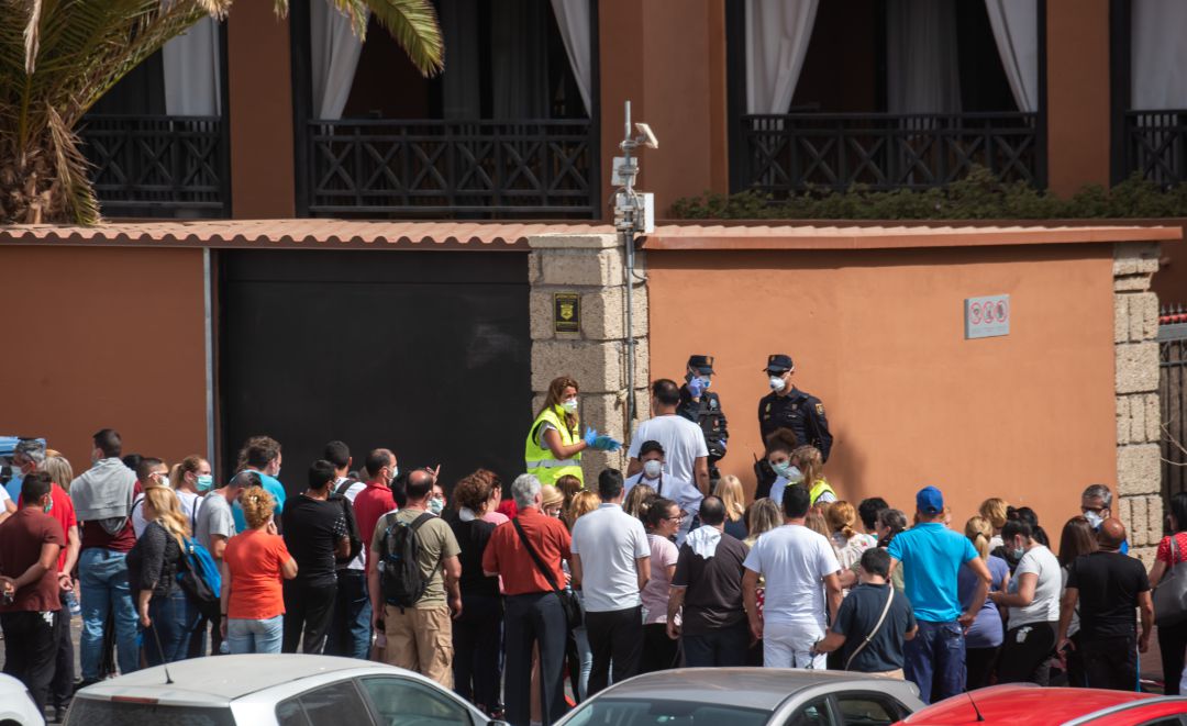 Un grupo de psicólogos habla con trabajadores fuera del hotel. Un grupo de psicólogos habla con trabajadores fuera del hotel.