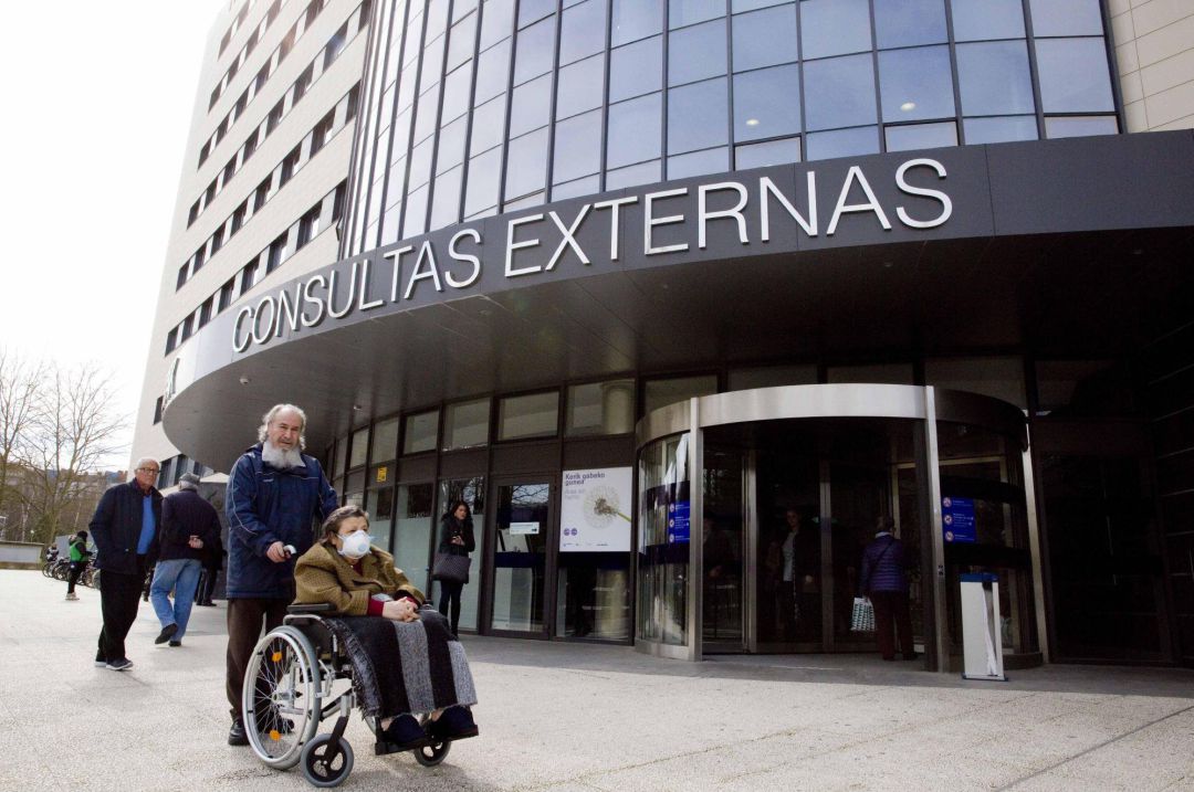 Una mujer con mascarilla en el acceso al edificio de Consultas Externas de Vitoria Una mujer con mascarilla en el acceso al edificio de Consultas Externas de Vitoria