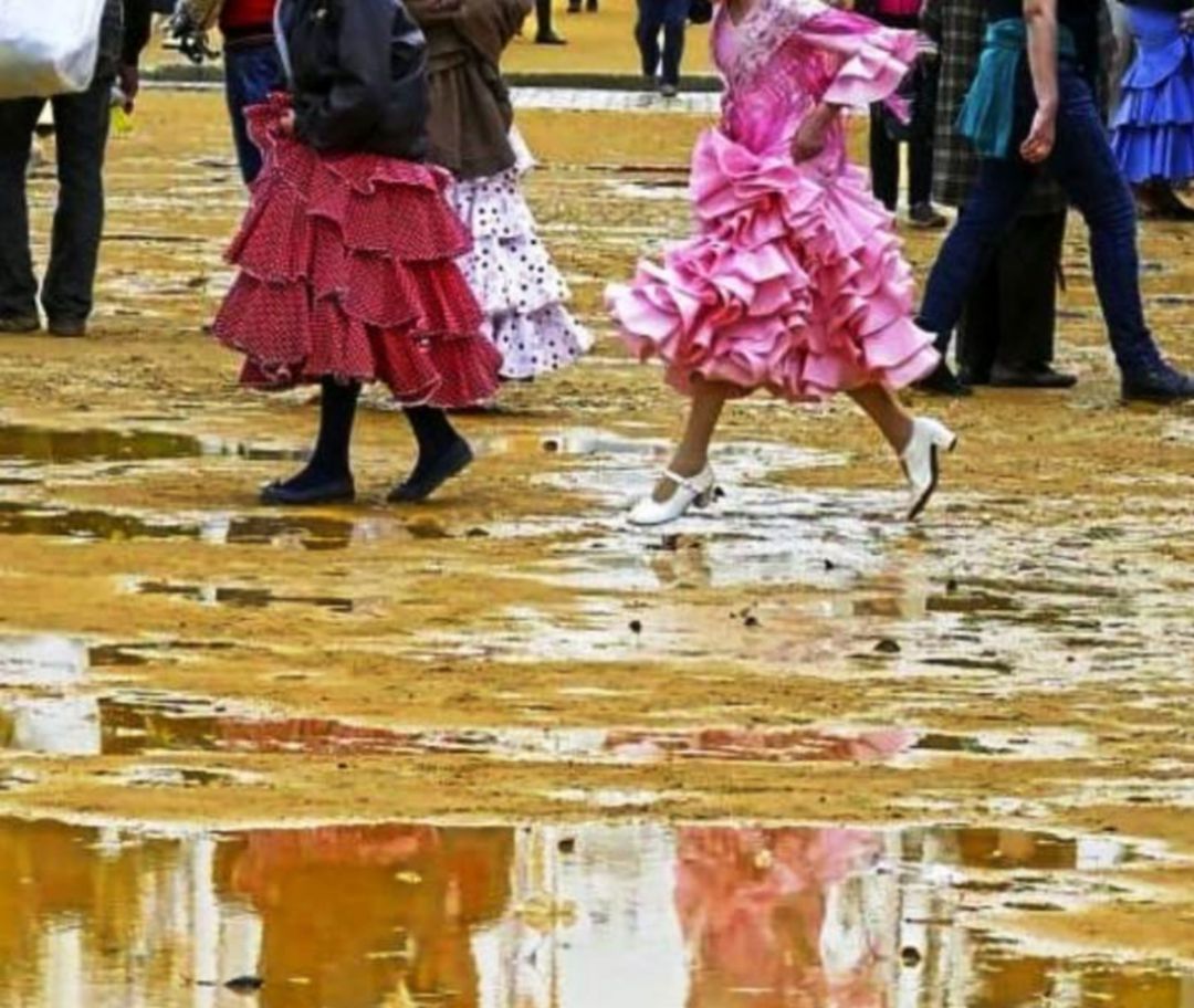Jóvenes vestidas de gitana sortean charcos en el albero del Real Jóvenes vestidas de gitana sortean charcos en el albero del Real