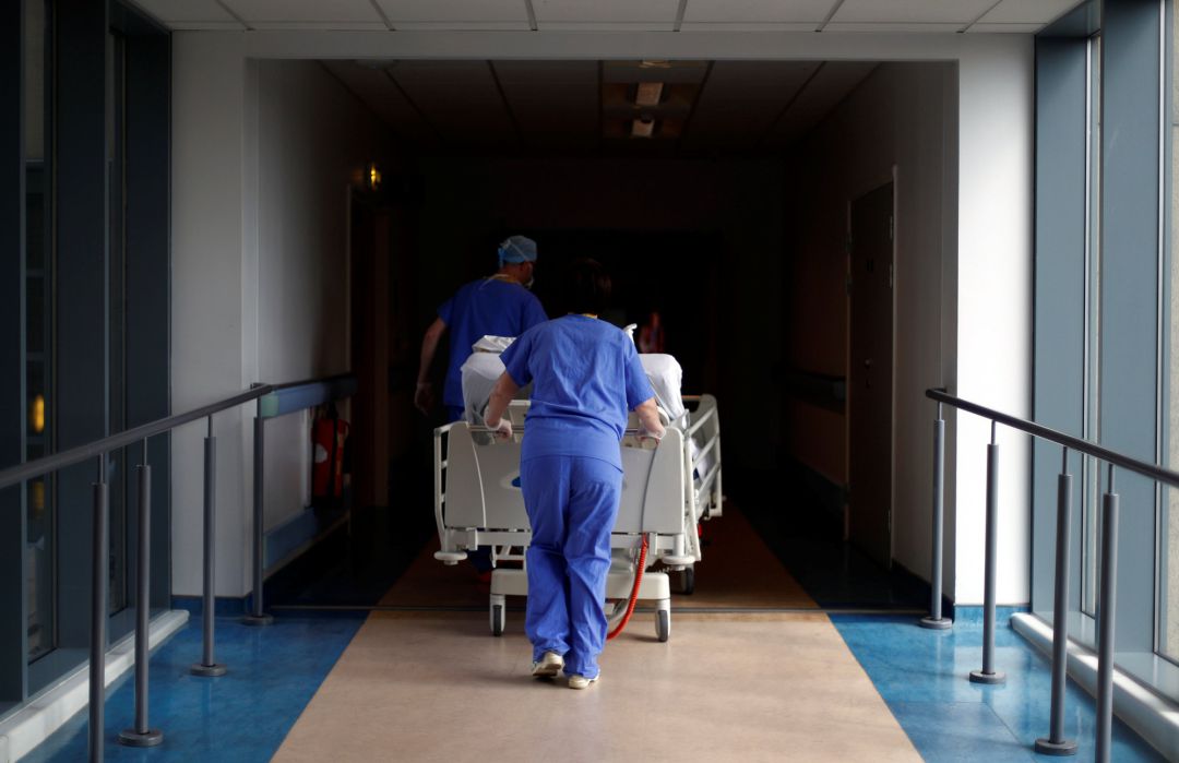 Medical staff transfer a patient through a corridor at The Royal Blackburn Teaching Hospital in East Lancashire, during the current coronavirus disease (COVID-19) epidemic, on May 14, 2020 in Blackburn, England. Medical staff transfer a patient through a corridor at The Royal Blackburn Teaching Hospital in East Lancashire, during the current coronavirus disease (COVID-19) epidemic, on May 14, 2020 in Blackburn, England.