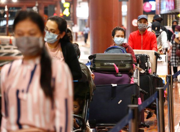 Passengers stand in line to have documents checked at a Soekarno Hatta Airport amid the coronavirus disease (COVID-19) outbreak in Jakarta, Indonesia, May 21, 2020. REUTERS/Ajeng Dinar Ulfiana