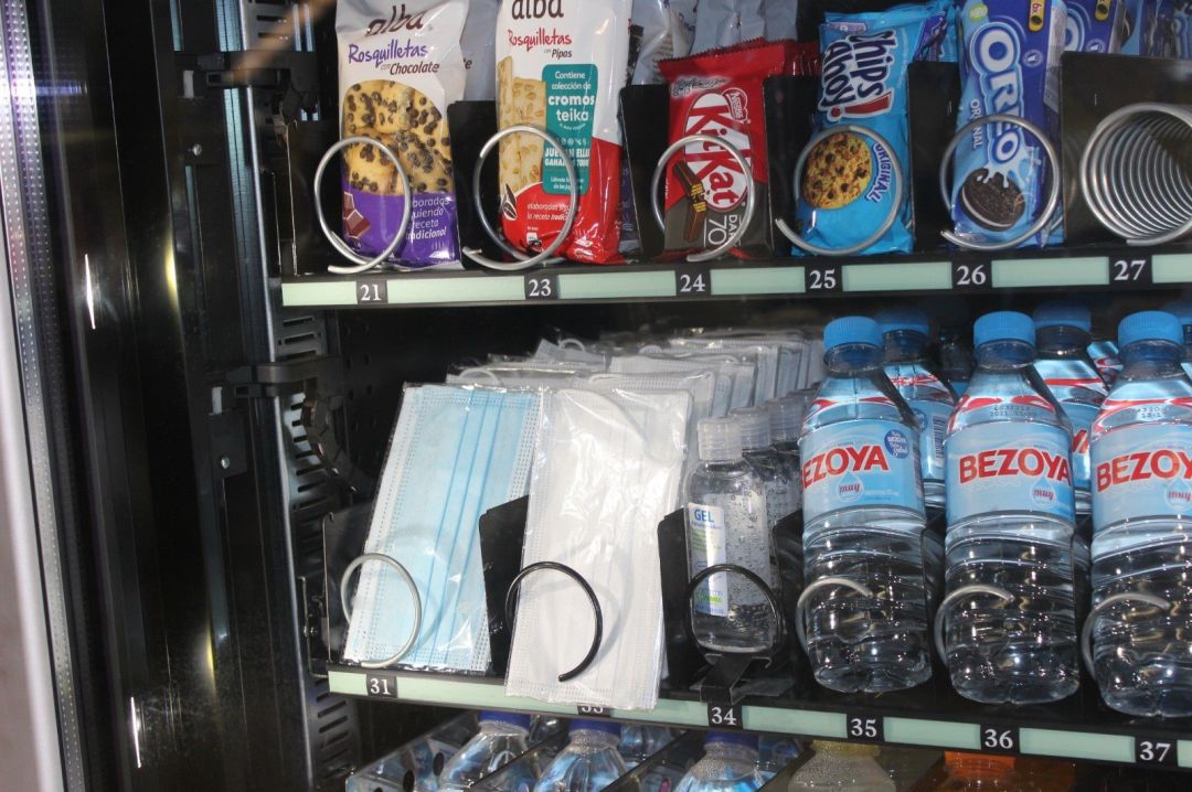 Mascarillas y gel en una máquina en una estación Mascarillas y gel en una máquina en una estación