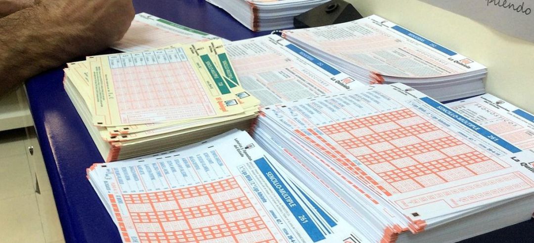 Una persona completa un boleto de lotería en una Administración. Una persona completa un boleto de lotería en una Administración.