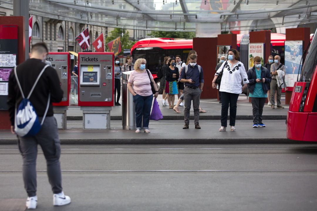 Passengers wearing protective masks wait for a tram in Bern, Switzerland, Passengers wearing protective masks wait for a tram in Bern, Switzerland,