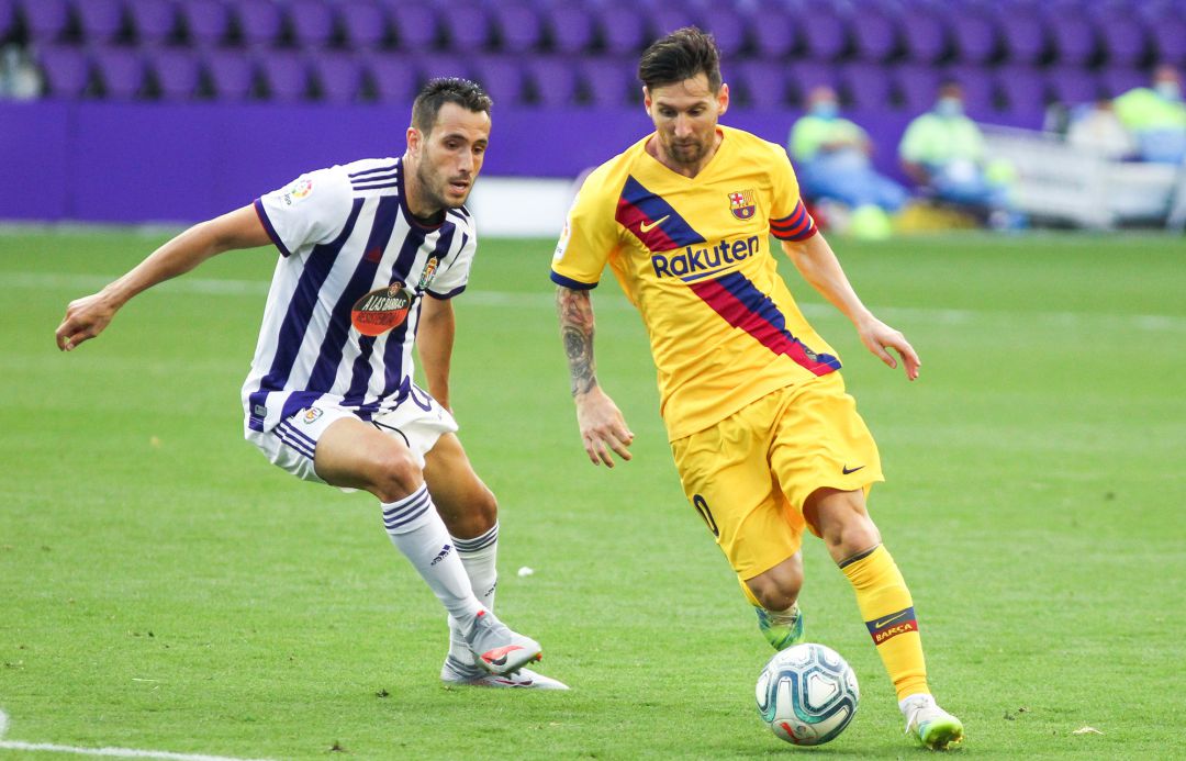 Lionel Messi of FC Barcelona and Kiko Olivas of Real Valladolid Lionel Messi of FC Barcelona and Kiko Olivas of Real Valladolid