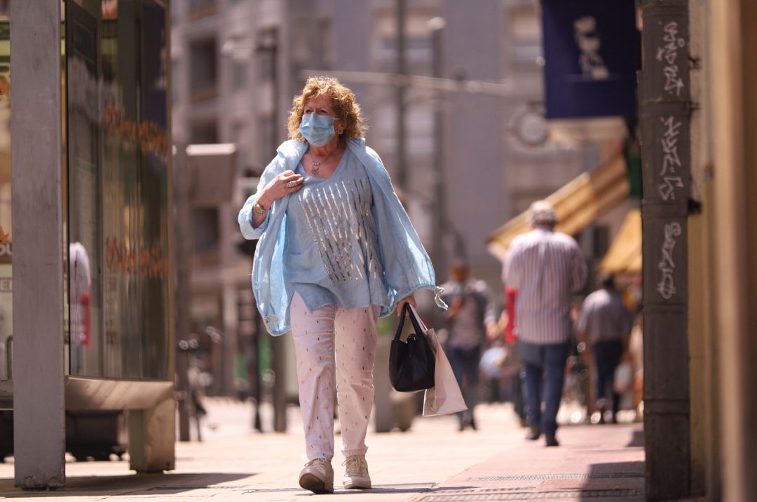 Una mujer pasea con mascarilla por una céntrica calle de Vitoria Una mujer pasea con mascarilla por una céntrica calle de Vitoria