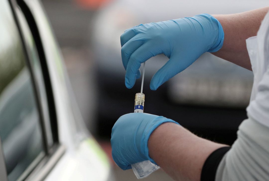 Un profesional sanitario recoge una muestra de test de coronavirus realizada a una persona desde un coche. Un profesional sanitario recoge una muestra de test de coronavirus realizada a una persona desde un coche.