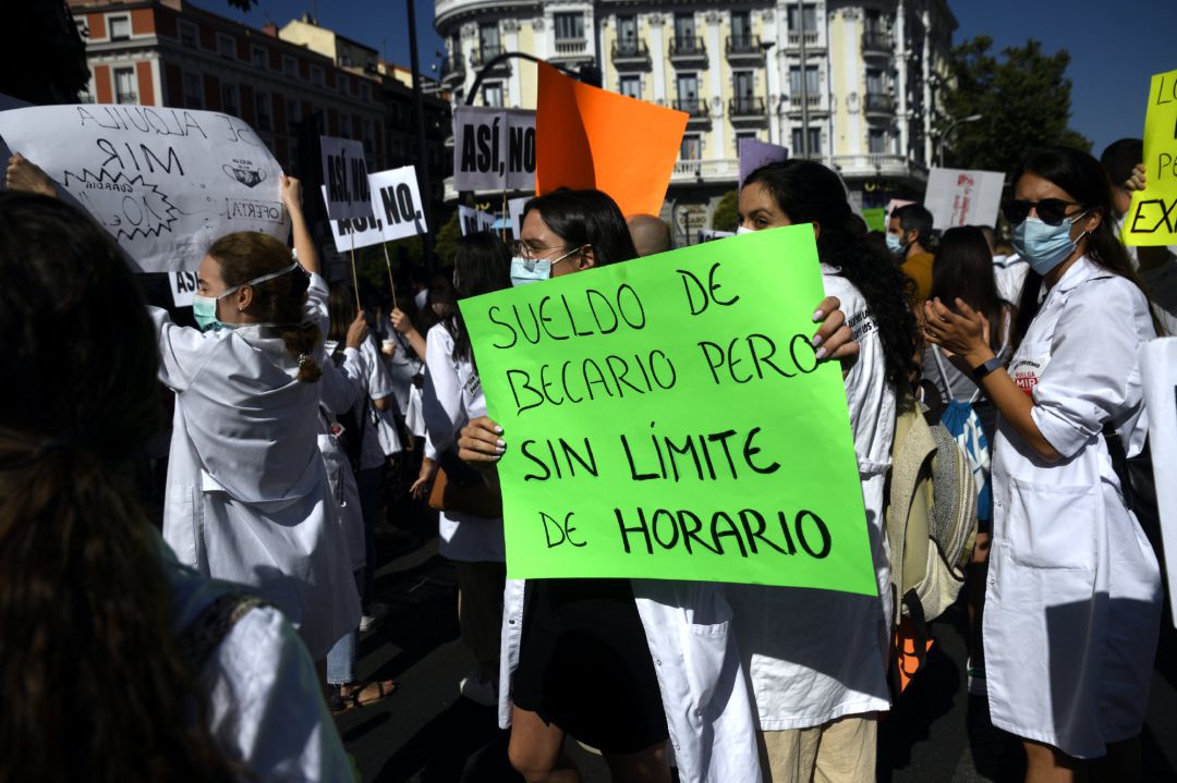 Una sanitaria sostiene un cartel en el que se lee 'Sueldo de becario pero sin límite de horario' durante una manifestación MIR Una sanitaria sostiene un cartel en el que se lee 'Sueldo de becario pero sin límite de horario' durante una manifestación MIR