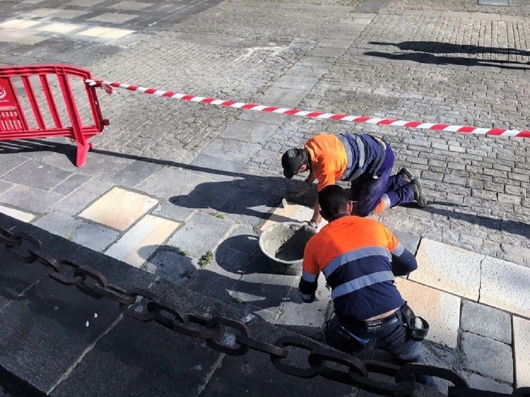 Dos operarios trabajan en una calle Dos operarios trabajan en una calle