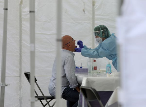 Una sanitaria le realiza un frotis bucal a un vecino de Ordizia en una de las carpas instaladas en el parque Barrena por el Ayuntamiento de Ordizia.