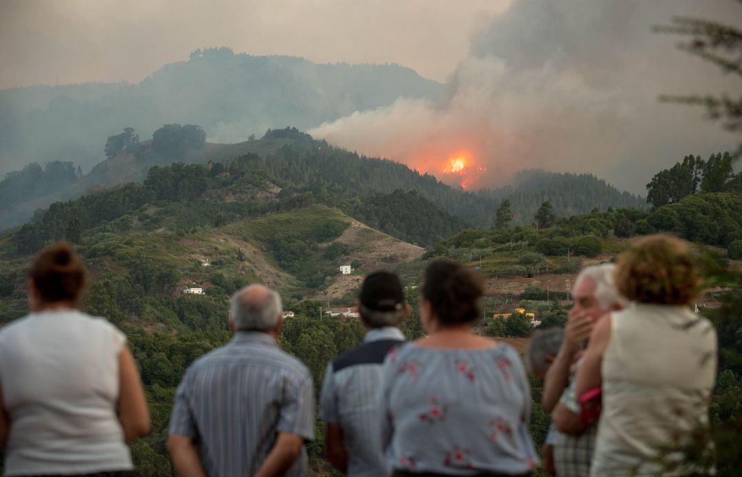 Vecinos de un municipio de Gran Canaria ven aproximarse el fuego a sus casas durante el gran incendio forestal ocurrido en el mes de agosto de 2019. Vecinos de un municipio de Gran Canaria ven aproximarse el fuego a sus casas durante el gran incendio forestal ocurrido en el mes de agosto de 2019.