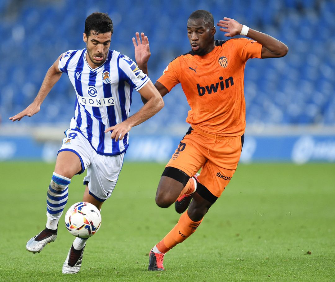 Mikel Merino of Real Sociedad runs with the ball under pressure from Geoffrey Kondogbia of Valencia CF Mikel Merino of Real Sociedad runs with the ball under pressure from Geoffrey Kondogbia of Valencia CF