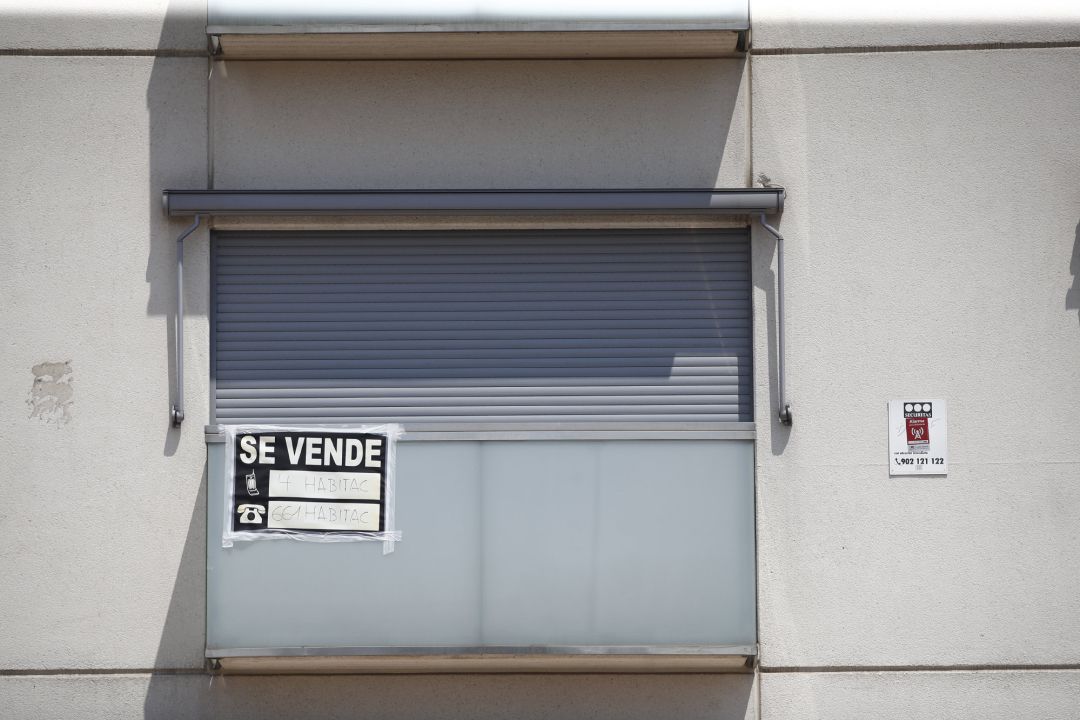 Cartel de 'se vende' en el balcón de un piso de un edificio. Cartel de 'se vende' en el balcón de un piso de un edificio.